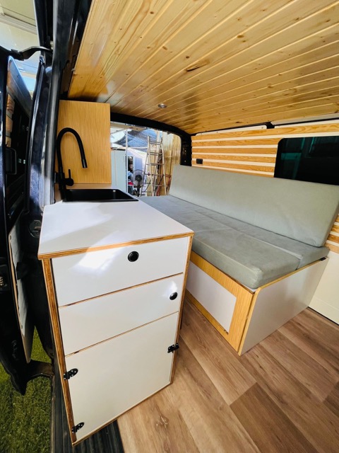 	Modern camper van interior layout in Volkswagen T6 with kitchen and storage